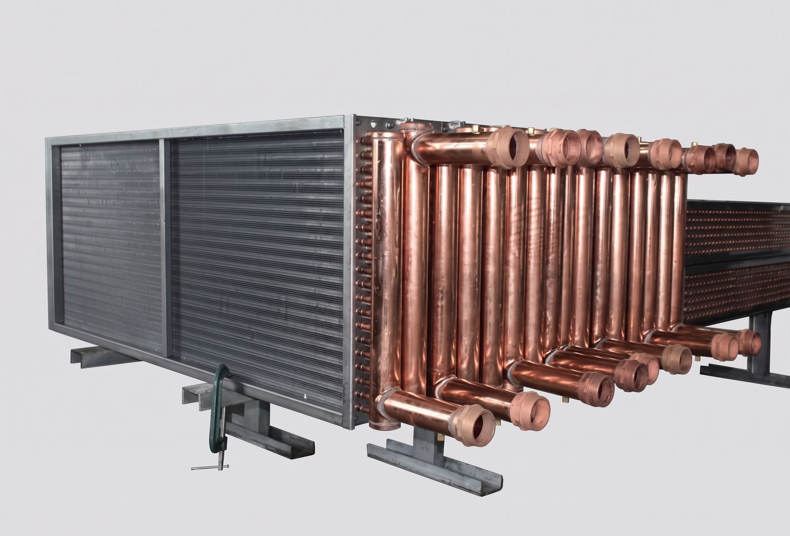 Bare fin and tube process coil with aluminum fins, heavy copper headers and large diameter manifolds with grooved connection stubs.