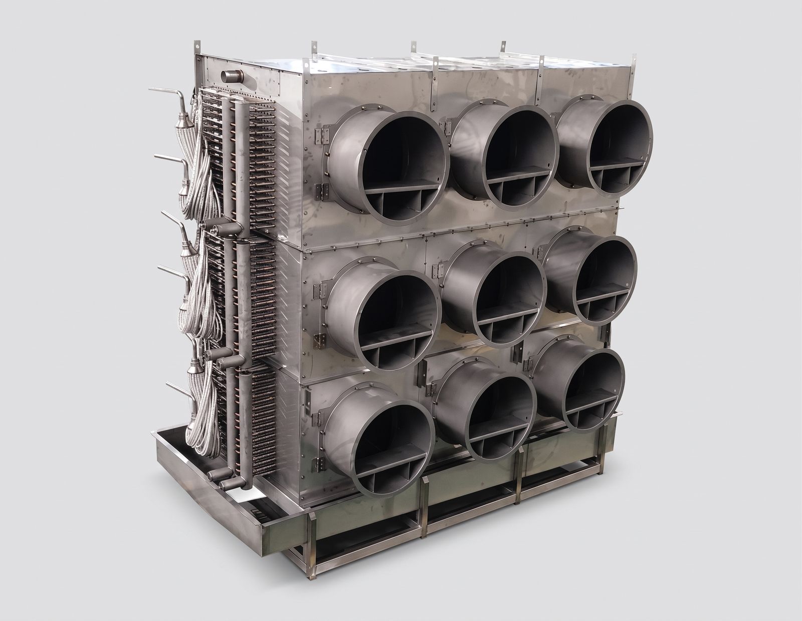 Stainless custom evaporator block with nine circular fan discharge collars in a three by three array and exposed copper circuiting.